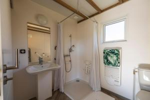 a bathroom with a sink and a shower at Camping Domaine Saâne et Mer in Quiberville +20 photos