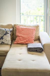 a couch with pillows on it in a living room at Sousa Horizonte - Louredo in Vieira do Minho +70 photos
