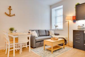 a living room with a couch and a table at Apt 1 Armatage Flats, Eyemouth in Eyemouth
