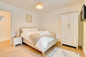 a bedroom with a bed and a dresser and a tv at Apt 1 Armatage Flats, Eyemouth in Eyemouth