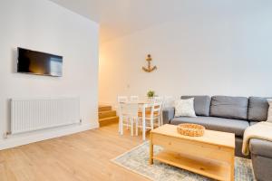 a living room with a couch and a table at Apt 1 Armatage Flats, Eyemouth in Eyemouth