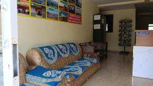 a couch in a store with blue and white blankets at Hotel Sunrise, Panchgani in Panchgani