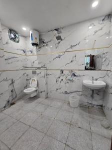 a bathroom with two toilets and a sink at Hotel The Castle Inn in Varanasi