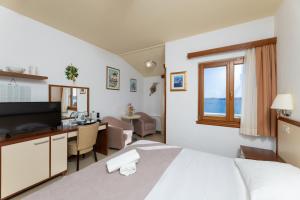a hotel room with a bed and a desk at SEGET ESTATE Beachfront Oasis & Tradition since 1964 - Split Trogir Riviera in Trogir