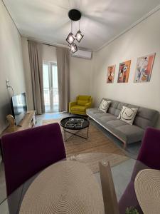a living room with a couch and a table at Feels Like Home 2 - Agrinio Suites in Agrinio
