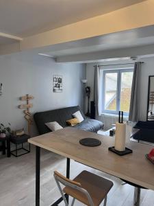 a living room with a table and a couch at Chez Nath House in Sedan