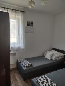 a small bedroom with a bed and a window at Idylla in Połom Mały +54 photos