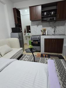 a living room with a couch and a kitchen at ML STUDIO with Rooftop, Free wifi, Free Parking in Nakuru