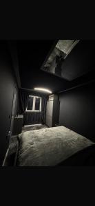 a dark room with a bed and a ceiling at La Garson in Borsa