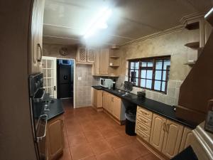 a large kitchen with black counter tops and a kitchen at 12 Bologna B&B in Evander