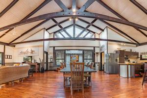 an open living room with a table and chairs at Umthiba Bush Lodge in KwaNibela