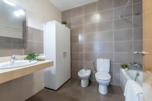 a bathroom with a toilet and a sink at Jouvacations Ripolles Figueres-Vilafant in Vilafant +34 photos