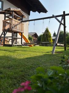 a park with a swing set and a slide at Appartement Wiederkehr in Flachau