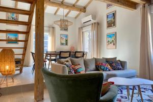 a living room with a couch and a table at Holiday Home nature and swimming pool in Provence ! in Mérindol
