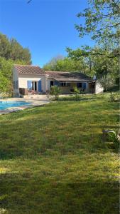 a house with a yard and a swimming pool at Holiday Home nature and swimming pool in Provence ! in Mérindol