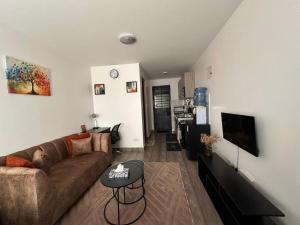 a living room with a couch and a table at Joto House in Muchatha