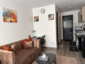 a living room with a couch and a table at Joto House in Muchatha