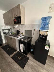 a small kitchen with a stove and a refrigerator at Joto House in Muchatha +16 photos