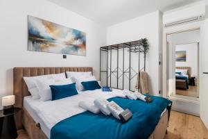 a bedroom with a large bed with blue and white at Euphoria Animar & Tiema in Draga Bašćanska +86 photos