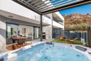 an indoor swimming pool in a house with a patio at Euphoria Animar & Tiema in Draga Bašćanska