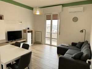 a living room with a couch and a table at Maison Regina in Vigevano