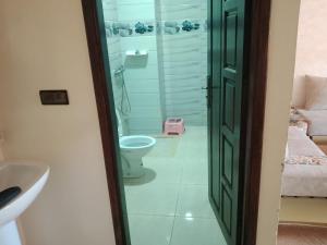 a bathroom with a toilet and a sink at اقامة الشام in Laayoune