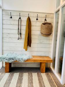 a wooden bench against a wall with a basket at Peartree Cottage in Sandhoe +33 photos