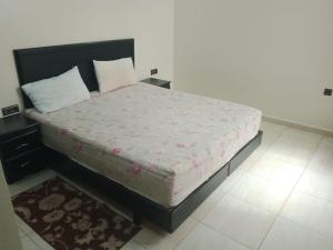 a bedroom with a large bed with pink sheets at اقامة الشام in Laayoune