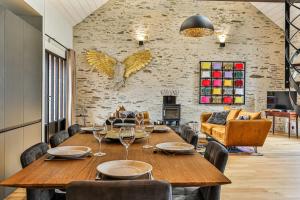 a dining room with a wooden table and chairs at Welcome to Villa Floréal Your tranquil retreat with spa in Saint-Gilles-Croix-de-Vie