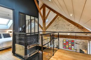 a loft conversion with a staircase and a bedroom at Welcome to Villa Floréal Your tranquil retreat with spa in Saint-Gilles-Croix-de-Vie
