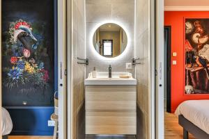 a bathroom with a sink and a mirror at Welcome to Villa Floréal Your tranquil retreat with spa in Saint-Gilles-Croix-de-Vie