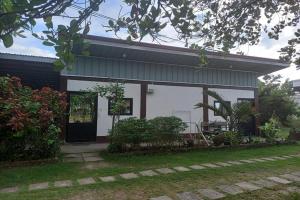a small white house with a black door at Seven Waves Beachfront Residence - La Union in Bagbag Oeste +32 photos