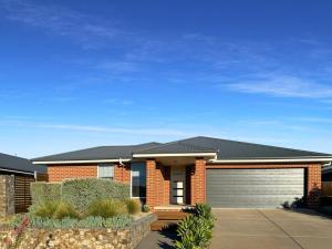 a red brick house with a garage at St Pauls Home in North Wagga