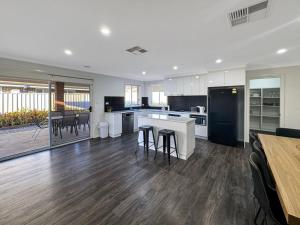 a large kitchen with a table and chairs in it at St Pauls Home in North Wagga