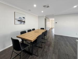 a conference room with a wooden table and chairs at St Pauls Home in North Wagga