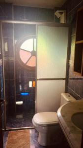 a bathroom with a toilet and a sink and a window at Hospedaria LARENA in Florianópolis +25 photos