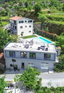 an aerial view of a house with a swimming pool at Sousa Horizonte - Louredo in Vieira do Minho