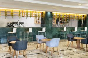 a bar with chairs and tables in a restaurant at AluaSun Costa Park in Torremolinos