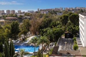 an aerial view of a resort with a pool and a city at AluaSun Costa Park in Torremolinos +40 photos