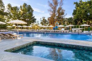 a pool with chairs and umbrellas at a resort at AluaSun Costa Park in Torremolinos