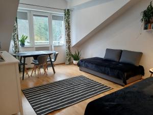 a living room with a couch and a table at Leśny Loft in Gdynia