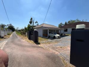 a house with a car parked in the driveway at Cahaya roomstay in Kangar