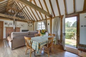 a living room with a table and a couch at 1 Bed in Tenterden oc-tn621 in Tenterden