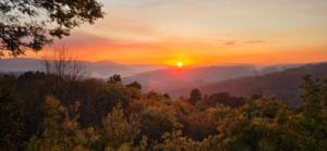 a sunset in the mountains with the sun setting at Bayo - terra essentia in Alge