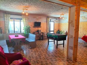 a living room with a table and a pool table at Hotel Monte Fior in Foza