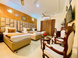 a hotel room with two beds and a television at World Inn by WIH in Karachi