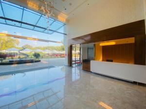 a large lobby with a large glass wall at The Manak Bagh in Sehore