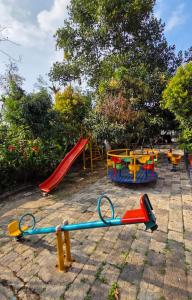 a playground with a red slide at Edakkal Pool Villa in Ambalavayal