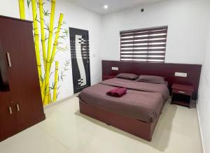 a bedroom with a large bed in a room at Edakkal Pool Villa in Ambalavayal +7 photos