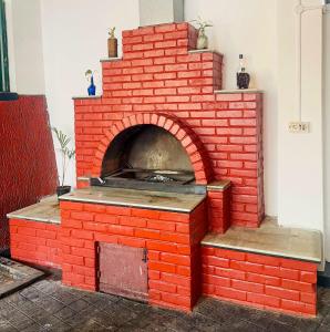 a red brick oven with a pizza inside at Edakkal Pool Villa in Ambalavayal